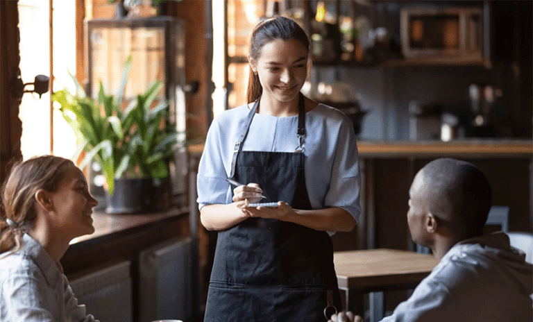 Waitress taking order of customers with a smile