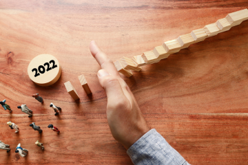 Man preventing dominoes falling risk management