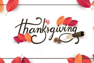 Happy Thanksgiving Sign with Autumnal Leaves in the background