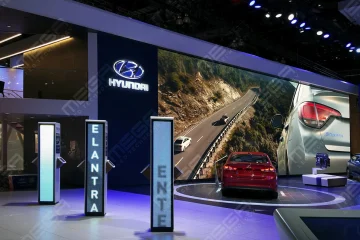 Large LED video wall displaying automotive visuals at a Hyundai booth in showroom environment