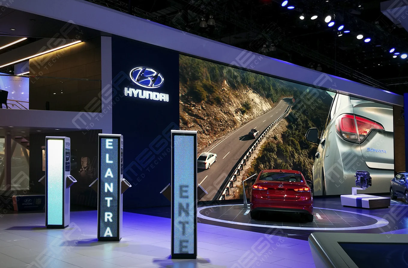 Large LED video wall displaying automotive visuals at a Hyundai booth in showroom environment