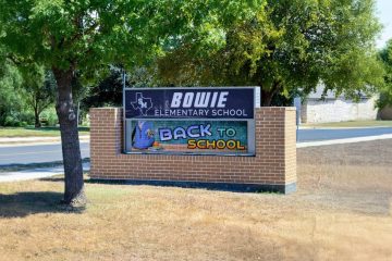 Outdoor LED message board at Bowie Elementary School displaying back to school announcement near a roadside campus entrance