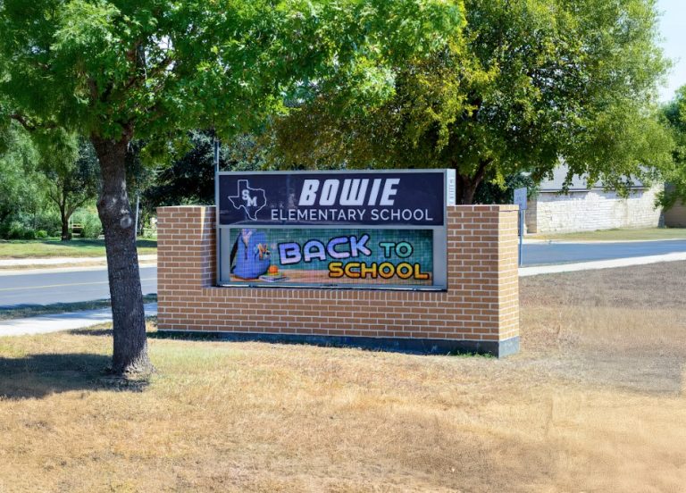Outdoor LED message board at Bowie Elementary School displaying back to school announcement near a roadside campus entrance