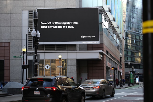 Outdoor digital billboard in a city promoting retail products and brand advertising on a wall mounted screen