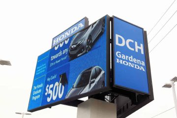 Outdoor double-sided LED digital billboard displaying Honda dealership advertisements on a roadside pylon sign.